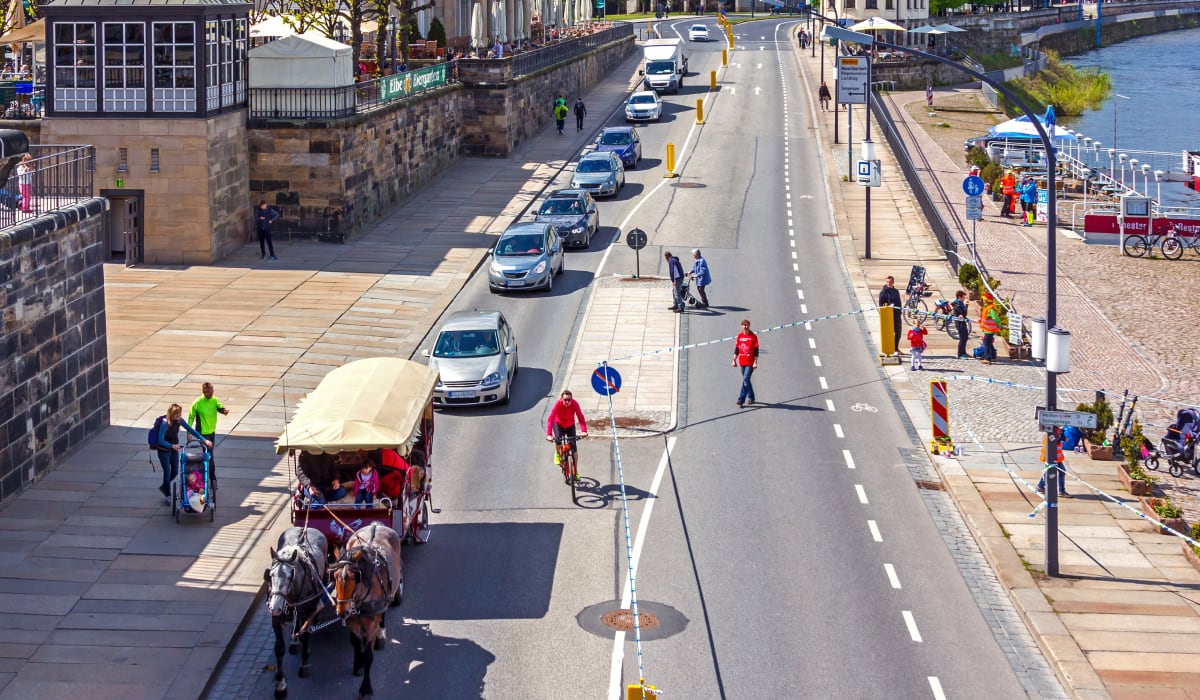 Cars and horse-drawn carriage in a traffic jam