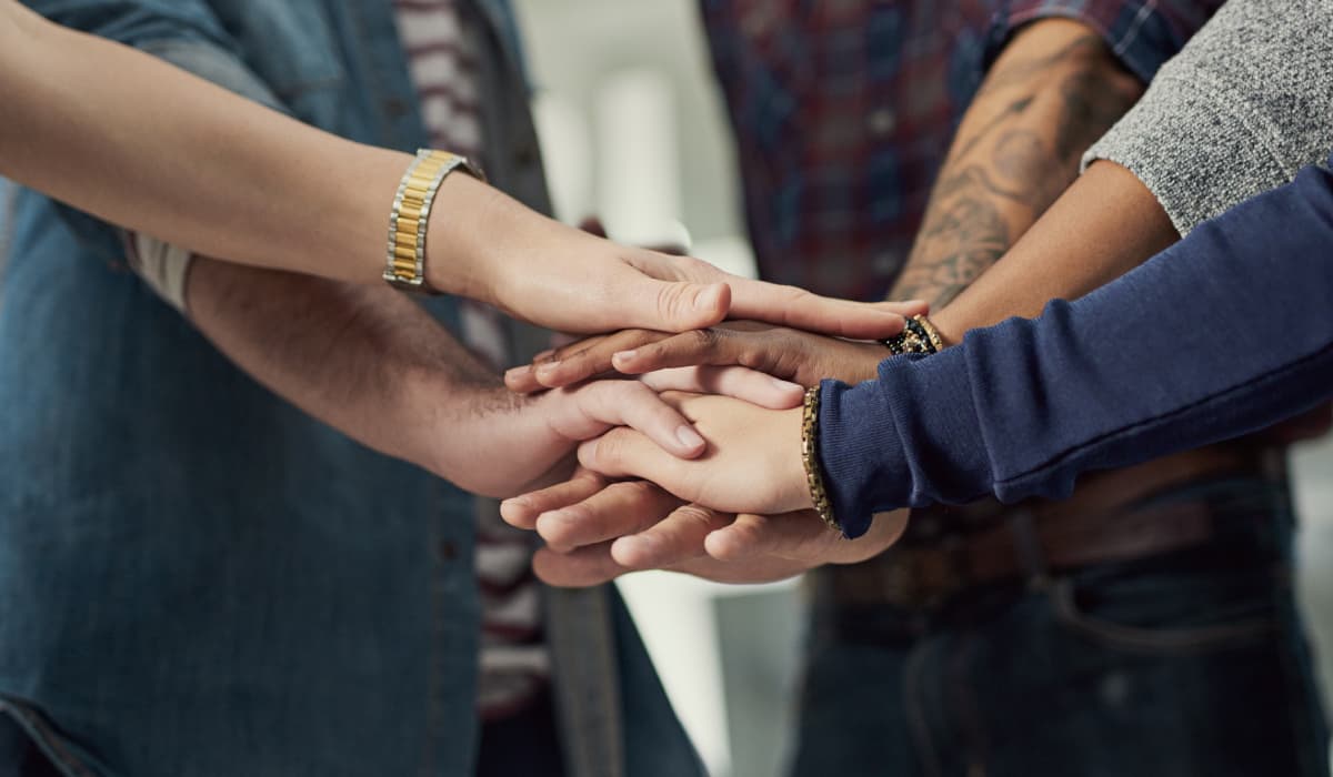 People stack several hands on top of each other