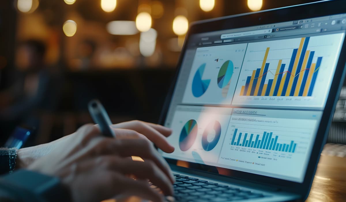 Hands on a laptop keyboard and several diagrams on the screen